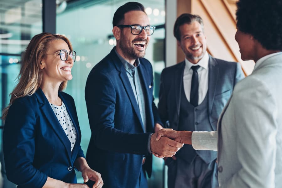 Group of business people shaking hands in office