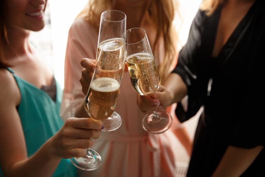 Guests clinking glasses of champagne during bridal shower